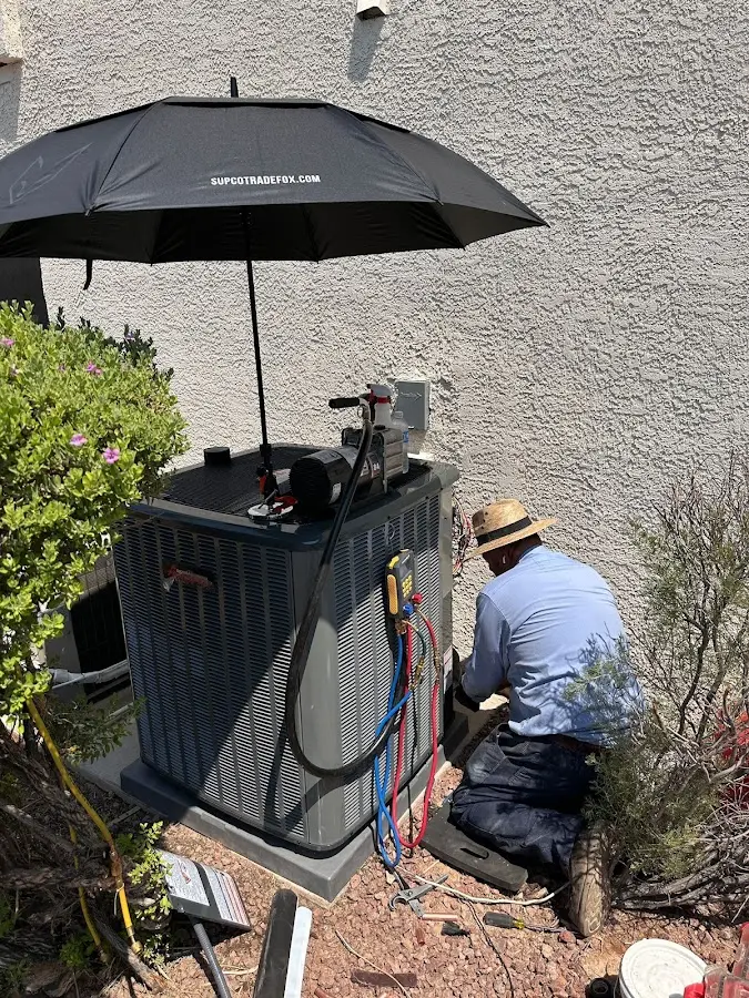 HVAC technician performing outdoor AC maintenance in Hatboro